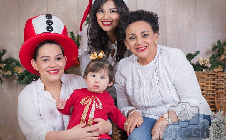 a family posing for a photo with a christmas tree
