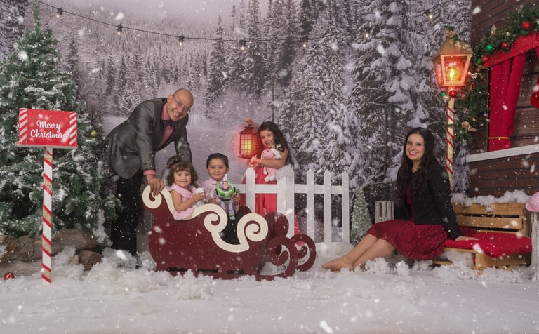 a family posing for a photo in a snowy scene