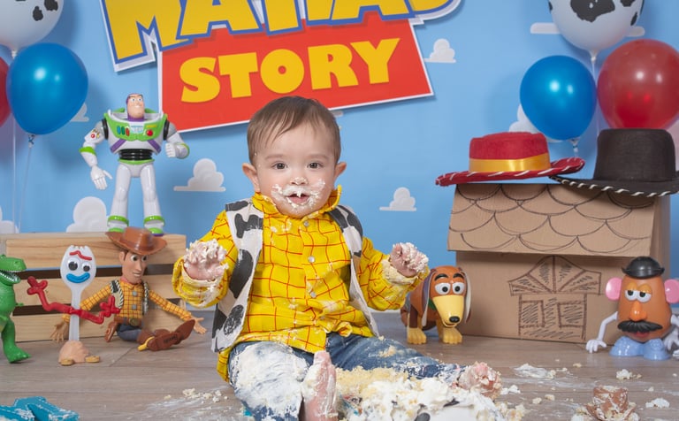 a baby boy in a yellow shirt and blue jeans
