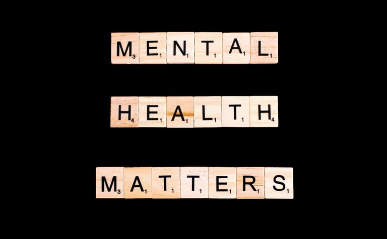 📝 Scrabble tiles spelling “Mental Health Matters” on black background