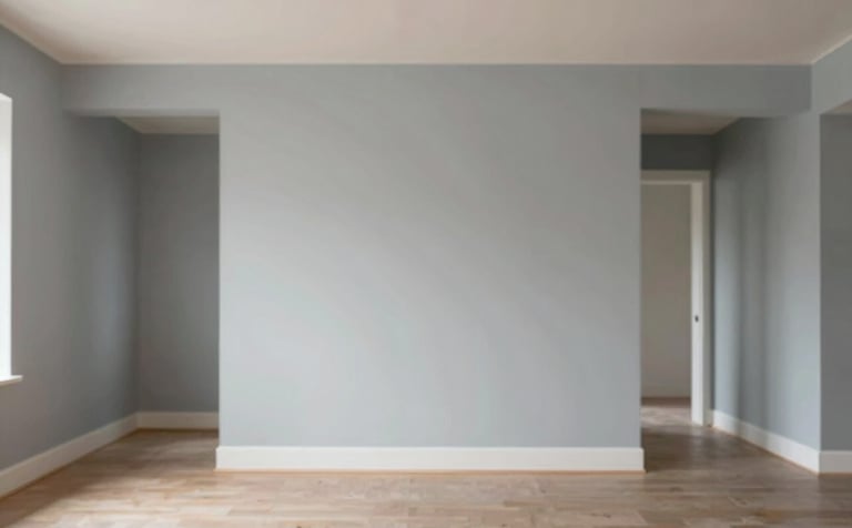 Interior shot of a renovated residential living space showing perfectly finished, smooth walls ready for paint. The lighting is warm yet professional. The aesthetic is clean and sturdy, reflecting high-quality residential work. Colors like #F8F9FA and #617488 appear in the architectural details.