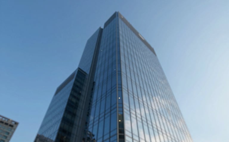 A low-angle shot of a modern glass skyscraper reflecting a clear blue sky, symbolizing corporate growth and stability. The style is clean and architectural. The color palette emphasizes #0A2A44 and #7BAED8 to evoke trust and authority.