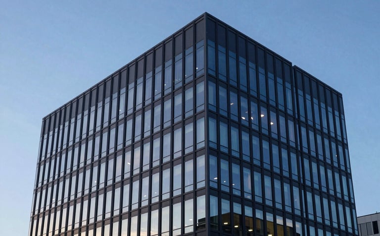 A sophisticated architectural photograph of a sleek North American office building exterior during the blue hour. Reflections in the glass show a clean sky. The atmosphere is quiet, stable, and profoundly professional, using sky blue and deep slate tones.