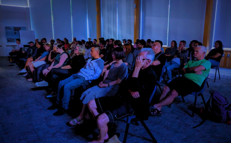 Audience immersed in a movie screening hosted by the Auckland International Film Club.