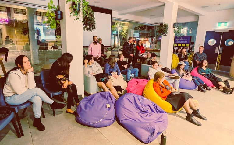 Attendees seated on bean bags during a post-screening discussion at Auckland International Film Club.