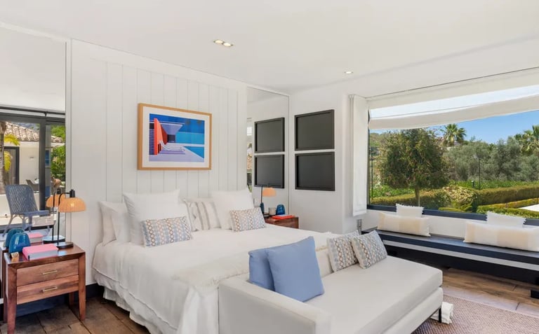 Guest suite with seating nook and garden views at Villa El Olivo, Marbella