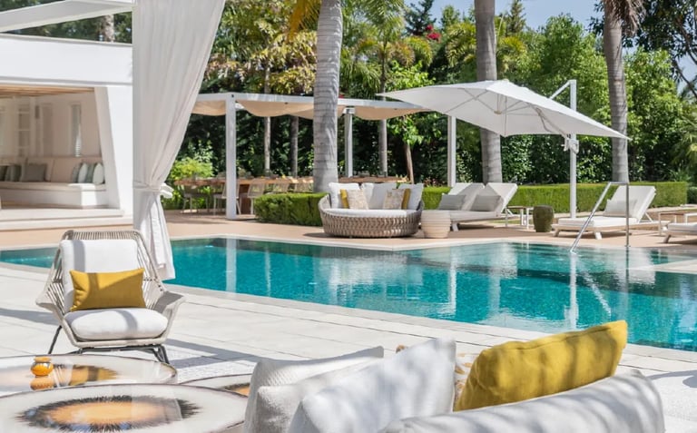 Villa Serenity poolside with daybeds and chic white pergola