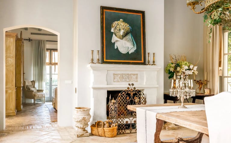 Fireplace with artwork and rustic decor at Finca Santa Katerina