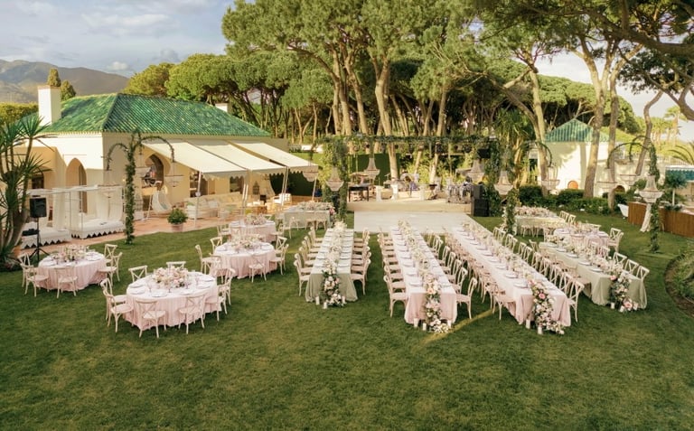 Luxury wedding setup at Villa El Rincon gardens with dining tables and decor