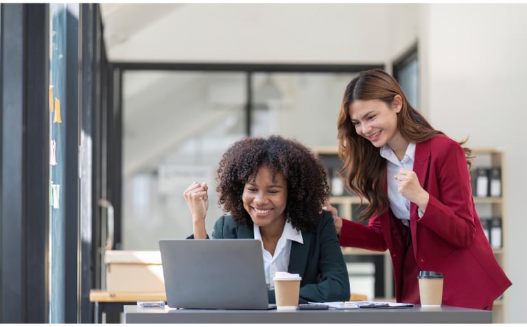 two women looking at laptop screen