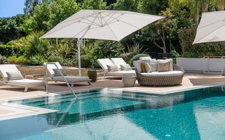 Pool area at Villa Serenity featuring modern furnishings, sunbathing lounges, and chill-out areas
