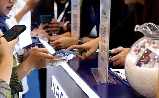 Visitor redeeming digital reward points at brand activation booth in Indonesia