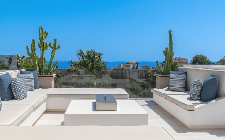 Rooftop lounge area with panoramic sea views at Villa Serenity