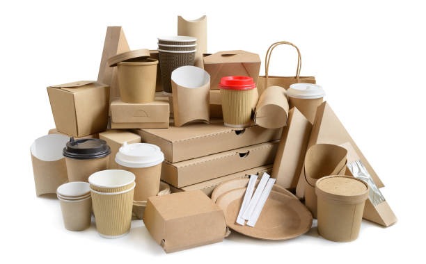 a pile of cardboard boxes with coffee cups and packaging board