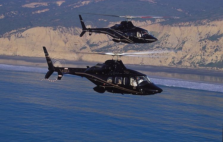 Two AW109 helicopters in flight, showcasing precision engineering and operational reliability.