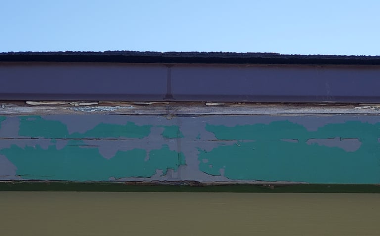 Rotting fascia board underneath drip edge. 