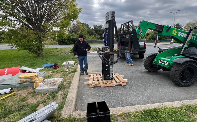 Fixing factory mistake on EV charger pedestals, New Castle, Delaware