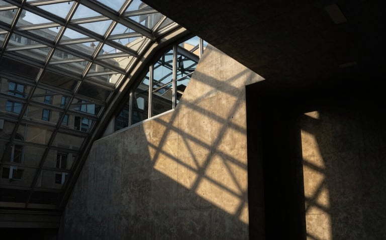 Low-key dramatic architectural close-up of a concrete and glass vault in Geneva, sharp geometric angles, dark shadows and gold light reflections, portrait aspect