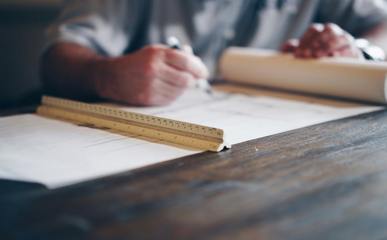 a man is working on a blueprint