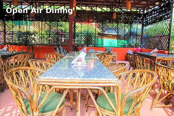 Outdoor dining area at Jungle Lore Resort with bamboo seating