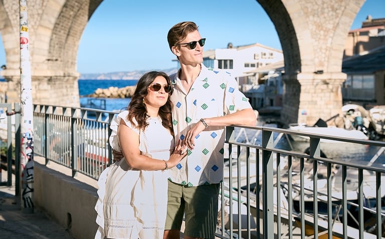 Relaxed couple portrait at Vallon des Auffes with fishing boats and iconic bridge