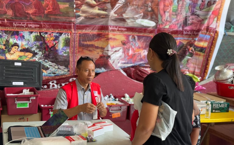 Nai Tun Tun is giving medicine to the patient