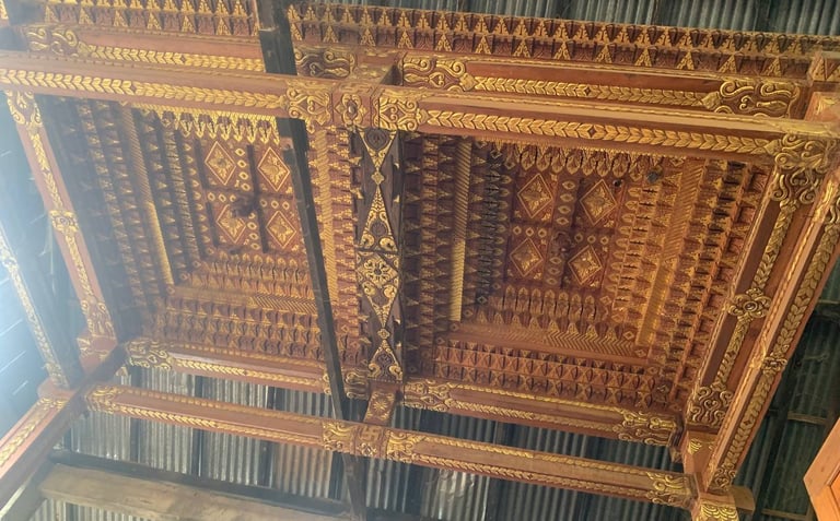 Intricate Joglo roof detail made from antique teak wood highlighting traditional Indonesian craftsmanship techniques