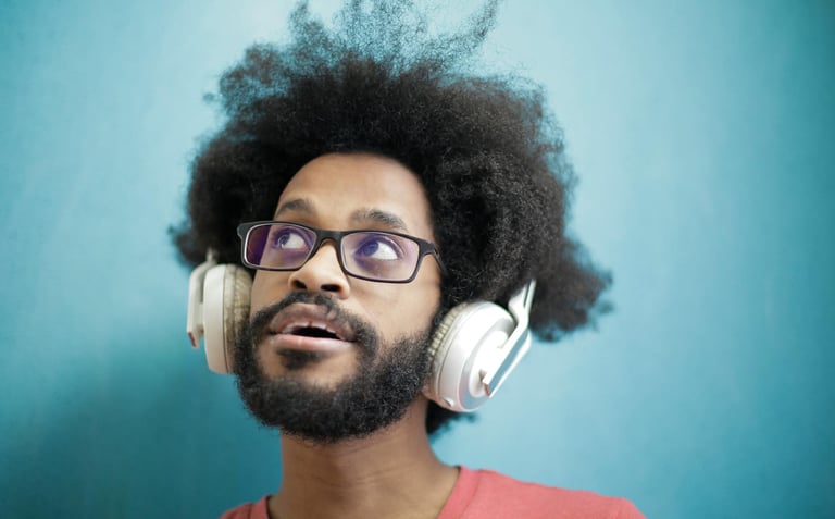 a man with a beard and glasses with headphones on