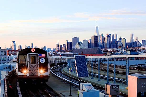 a train on the tracks in a city , in USA