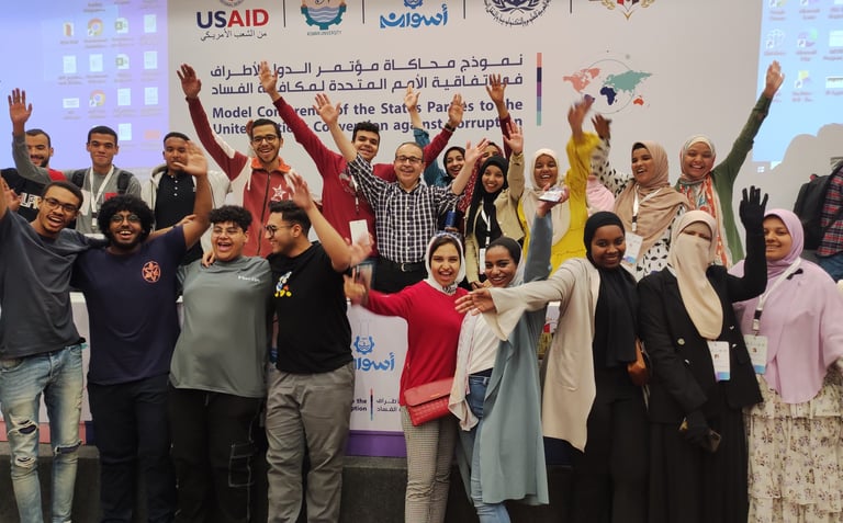 a group of people standing around a banner board