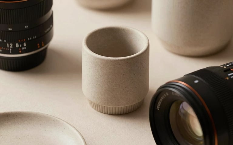 An elegant arrangement of premium materials, subtle textures, and soft shadows on a clean surface. Light beige and warm taupe tones.