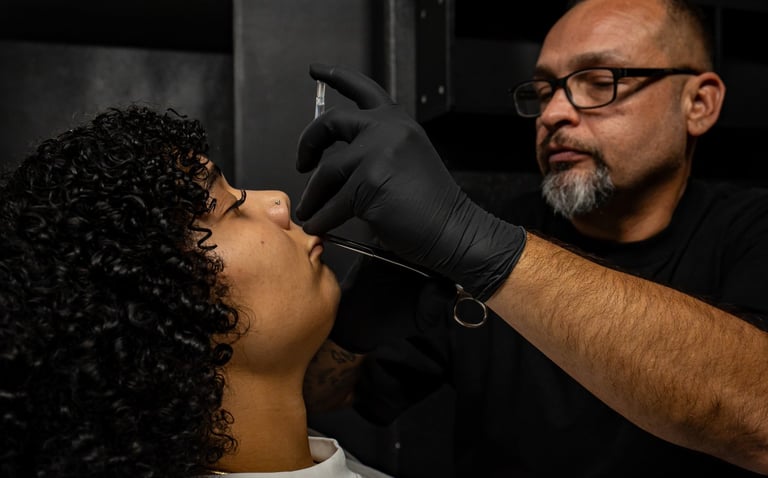 Matt doing a medusa piercing on a client