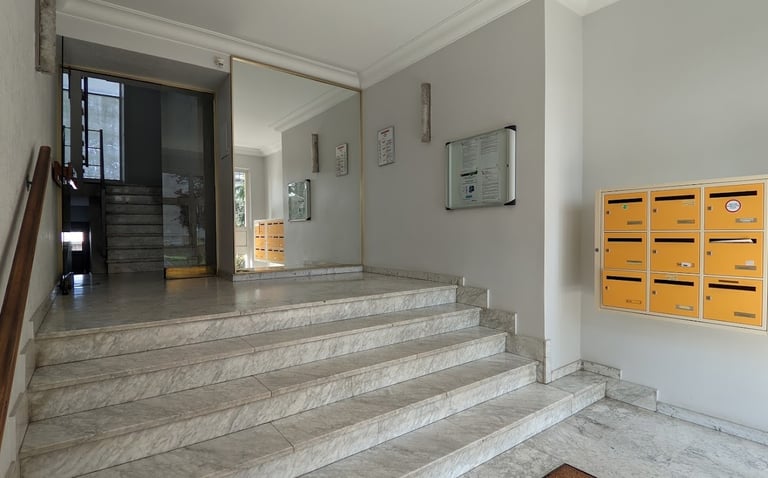 a staircase leading to a staircase way with mailboxes
