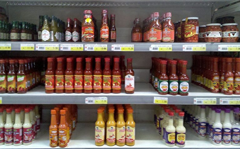 a variety of sauces and sauces on a shelf