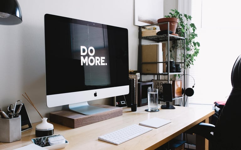 desk with monitor saying do more