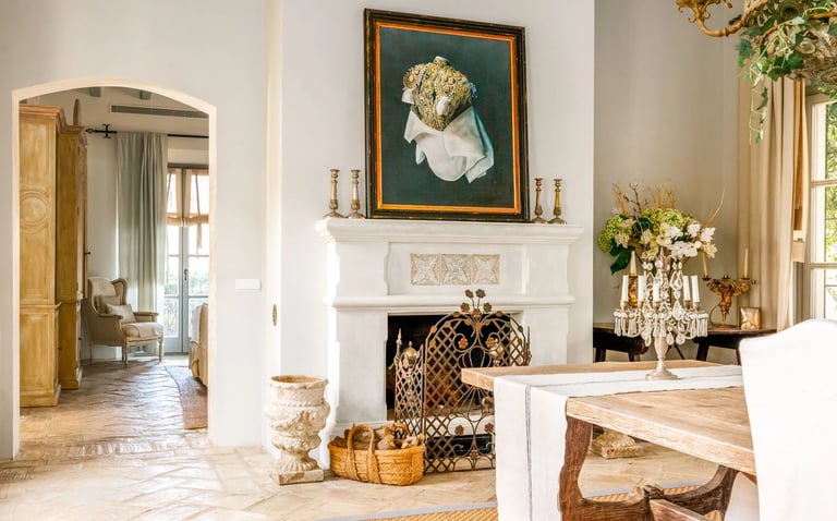 Fireplace with artwork and rustic decor at Finca Santa Katerina
