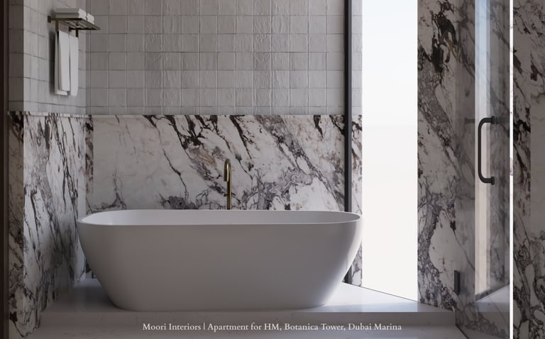 White tub in a bathroom with textured and Arabescato marble walls and a glass shower door.