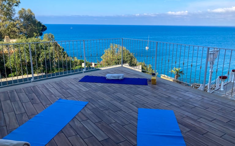 yoga class on terrace at hotel kalura in sicily facing the sea - yoga mats for asana