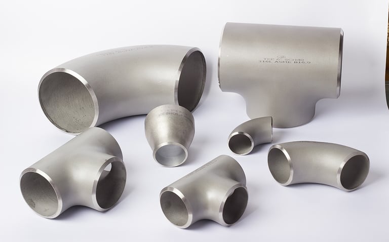 Assorted 316L stainless steel pipe fittings including elbows, tees, and reducers on a white background.