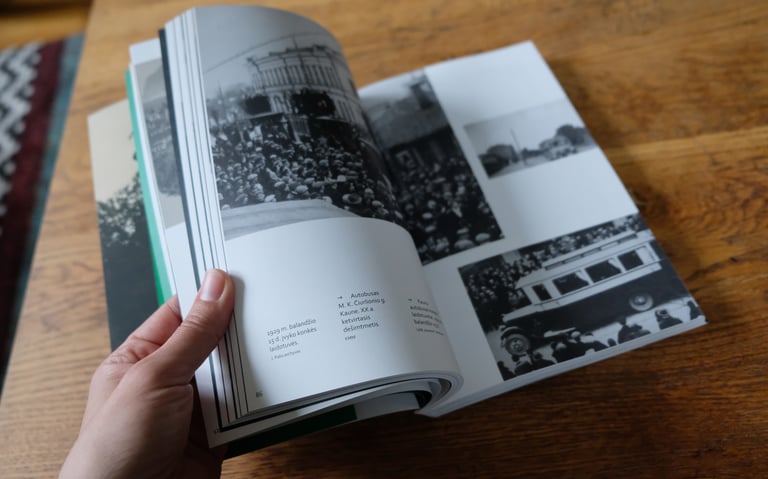 The photo shows the pages of a book being turned. Vintage photos are visible.