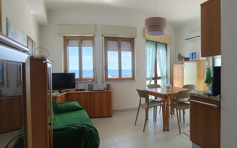a kitchen and dining room with a table and chairs
