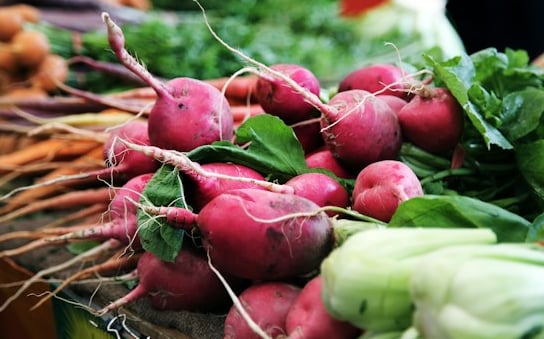 multiple beets and radishes around other vegetables