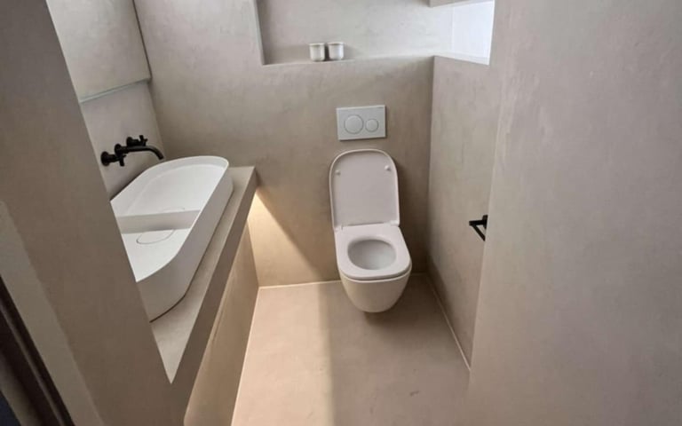 a bathroom with a toilet and a sink Bathroom with bathtub and wall mirror installed by PBP Services.