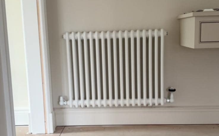 a white radiator on a wall installed by PBP Services in Evesham