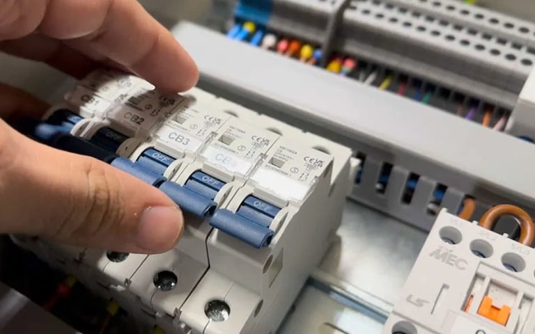 Suasana Electrical Services installing circuit breakers in DB box.