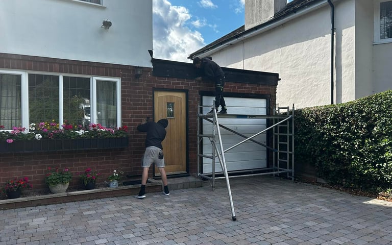 two men working on the front of a house in worcester