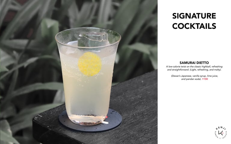 a glass of cocktail with a lemonade on a table