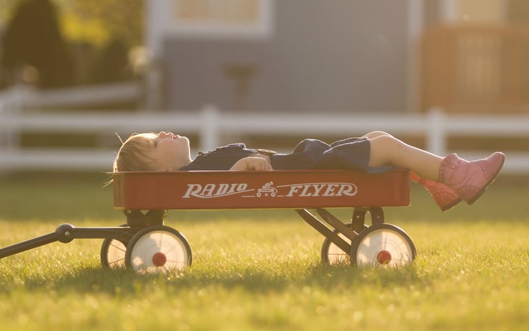 little boy sleeping outside