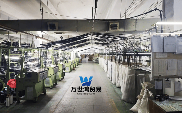 An industrial textile manufacturing plant equipped with automated weaving machinery and rows of zipp