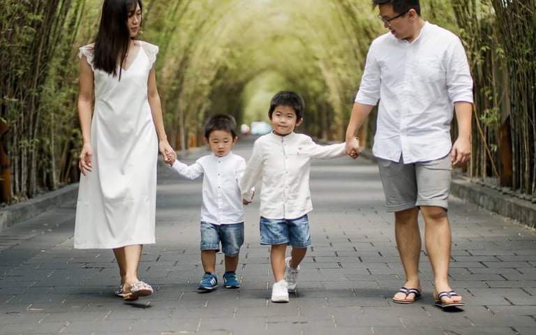 Family walking through the garden pathway during a family photography session at W Bali Seminyak